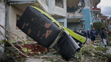 A truck is toppled against a home after a tornado in Havana, Cuba.