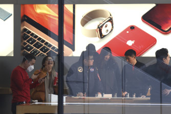 Customers at an Apple store in Beijing, where sales have slowed due to consumer anxiety over the trade war.