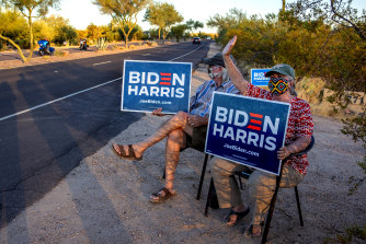 Linda and Tom Rawles, Arizona Republicans for Biden, spend four hours each day outside of their home in Carefree, Arizona, holding Biden Harris signs along the road, hoping to encourage voters to choose Joe Biden in the upcoming presidential election. 