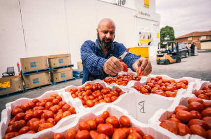 Frank DeAgostino from Lakes Fresh Food Market with a fresh delivery of tomatoes.