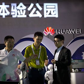 Visitors look at a display for 5G wireless technology from Chinese technology firm Huawei in Beijing.