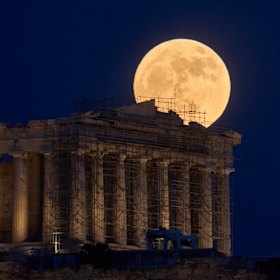 The Strawberry Moon behind the Parthenon in Athens, Greece.