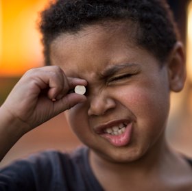 Three-year old Trent swallowed a button battery like the one he is holding. He was lucky to survive. 