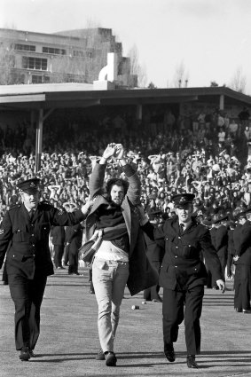 Police escort an anti-apartheid protester off the field at the Sydney Cricket Ground on 6 July 1971.