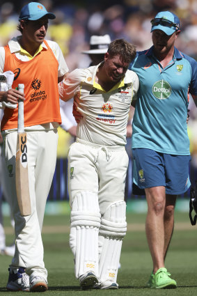 Warner is helped from the field, overwhelmed by cramps.