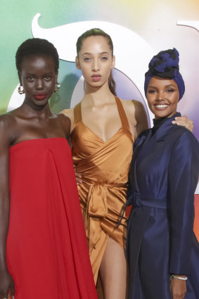 Halima Aden (right) with Australian model Adut Akech (left) and Yasmin Wijnaldum at the 2018 Business of Fashion gala.