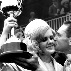 Jockey Jim Johnson with the Cup trophy being congratulated by his daughter Gail Johnson after winning.