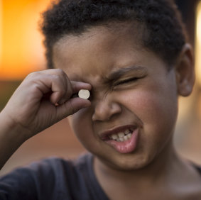 Three-year old Trent swallowed a button battery like the one he is holding. He was lucky to survive. 