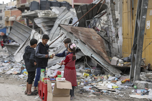 Palestinian children sell sweets outside a destroyed building in Jabaliya refugee camp in the Gaza Strip this week.