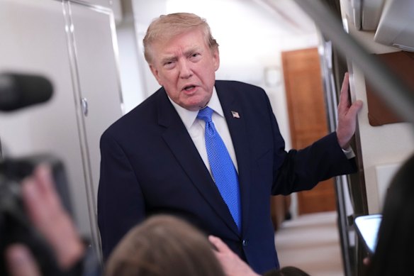 US President Donald Trump speaking to reporters on Air Force One on Sunday.