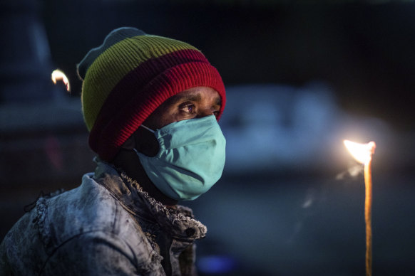 An Orthodox Christian lights a candle as people pray for peace in a church service in Addis Ababa, Ethiopia.