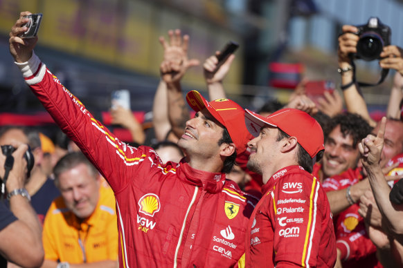 Ferrari driver Carlos Sainz, left, of Spain takes a selfie with teammate Charles Leclerc of Monaco after winning the Australian Formula One Grand Prix.
