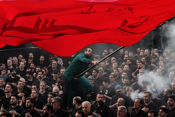 A man waves a religious flag at a mourning ceremony in Tehran honouring the 7th-century martyrdom of Prophet Muhammad’s grandson. The war has allowed hardliners to cement their position at the top of Iran’s power structure.