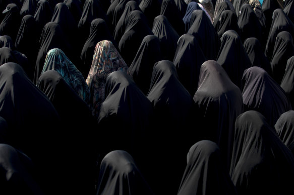 Iranian women praying under the leadership of Ali Khamenei at Tehran Mosque in Tehran.