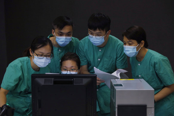 Medical workers make preparations at a temporary field hospital in Hong Kong at the weekend.