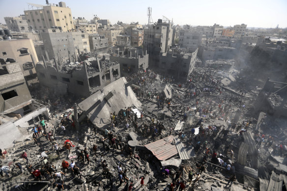 Palestinians inspect the rubble of destroyed buildings following Israeli airstrikes on town of Khan Younis, southern Gaza Strip, on Thursday.