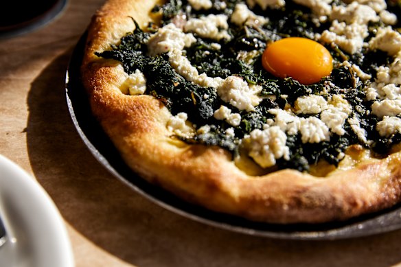 Rainbow chard flatbread, feta, confit garlic and egg yolk.