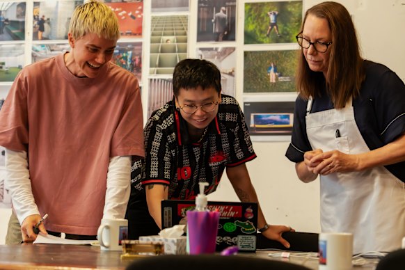 Jean Tong, centre, with Do Not Pass Go cast members Ella Prince, left, and Belinda McClory. 