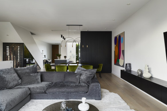“I originally intended just to repaint, but one thing led to another,” says Hansen. “Suddenly, there were plans to move the kitchen 
and elevate the whole house.” The open-plan living space features a sofa from Jardan and the dining table is from Zuster.