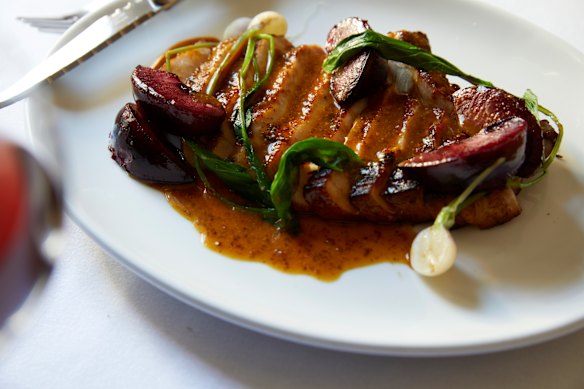 Pork cutlet with baby turnips and plums and mustard sauce.