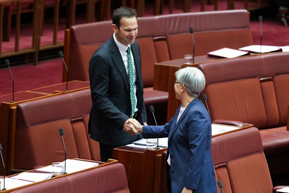 Penny Wong shakes Canavan’s hand.