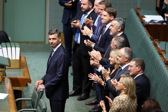 Coalition colleagues applaud Opposition Leader Angus Taylor as he concludes his speech.