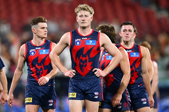 Jacob van Rooyen and his Demons teammate cast dejected figures after their horror show against Essendon.