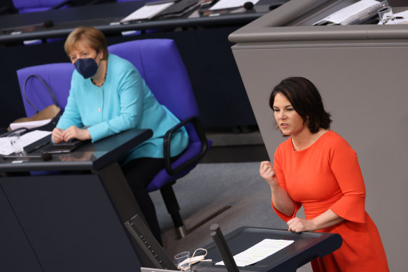 Greens Party chancellor candidate Annalena Baerbock, right, speaks after German Chancellor Angela Merkel,left, gave her last government declaration at the Bundestag on June 24.