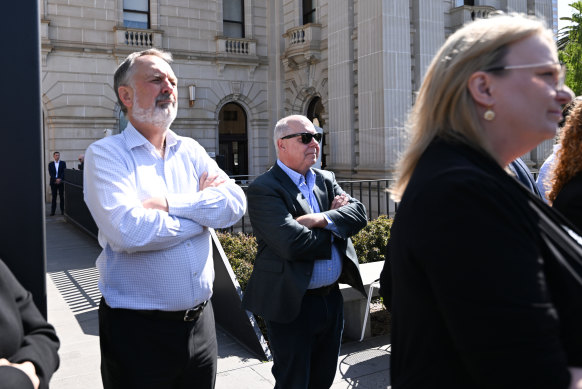 Treasurer Tim Pallas (centre) looks on as Victorian Premier Daniel Andrews announces his resignation.