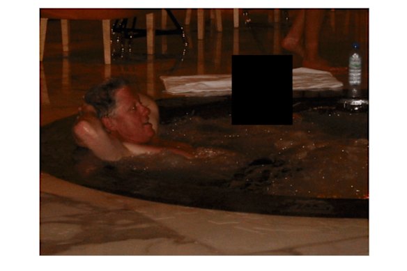 Bill Clinton in a hot tub with an unknown person.