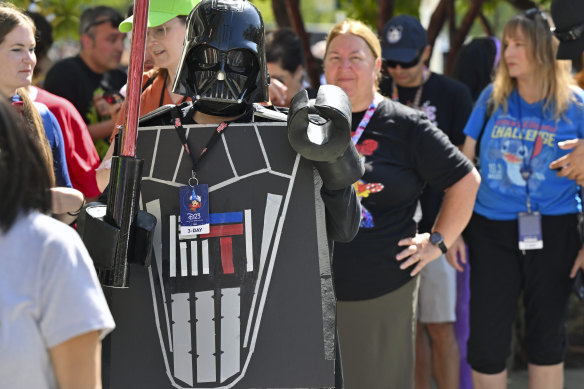 Andrea Feale is dressed as Lego Darth Vader outside the D23 convention.