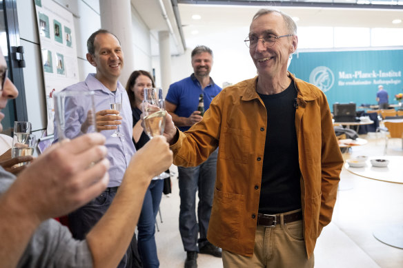 Svante Paabo toasts with champagne with his colleagues at the Max Planck Institute for Evolutionary Anthropology in Leipzig.