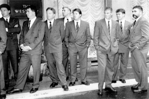 The Australian team arrives in London wearing olive suits that captured the attention of the British press.