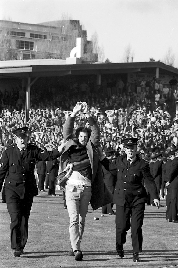 Police escort an anti-apartheid protester off the field at the Sydney Cricket Ground on 6 July 1971.