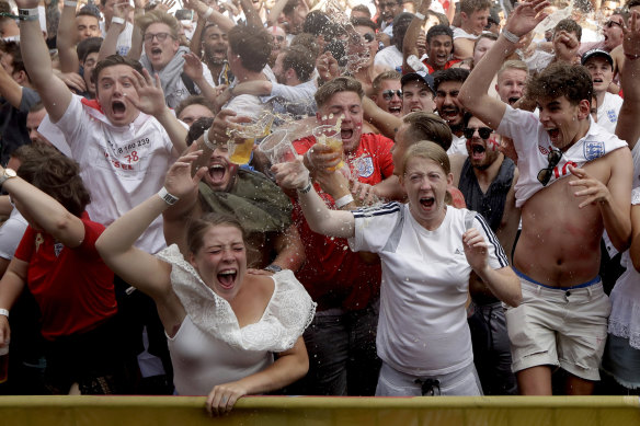 Oh yes: England soccer fans celebrate their second goal as they watch a live broadcast  in   London.