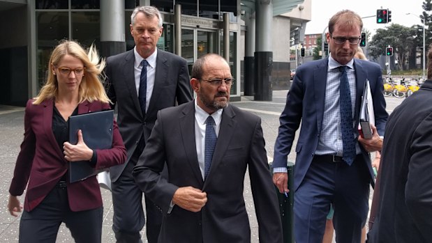 Ipswich City Council chief operating officer Craig Maudsley (centre) fronts court.