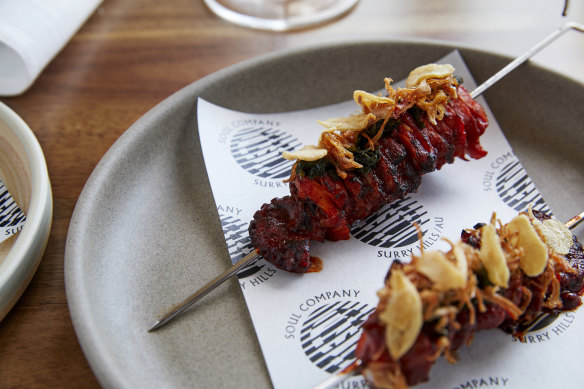 Grilled octopus skewers with pickled perilla leaf.