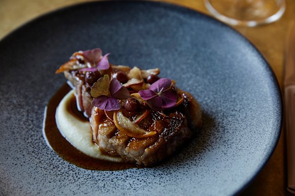 Kurobuta pork rack, pear, pickled muntries and smoked trotter jus.