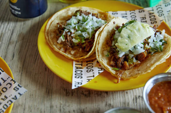Chipotle barbacoa beef taco (left) and al pastor pork and pineapple taco at Ricos in Redfern.