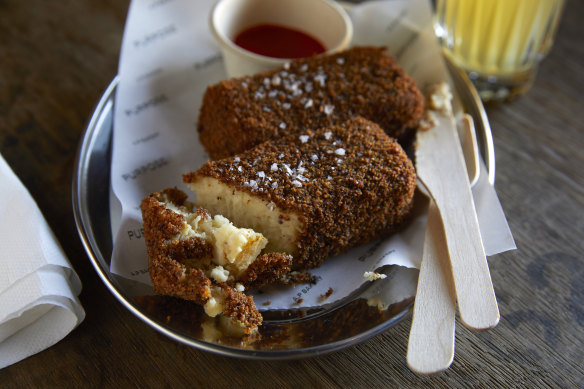 Cheese and cauliflower croquettes with hot sauce.