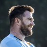 Jed Holloway laughing with Waratahs teammates at Leichhardt Oval.