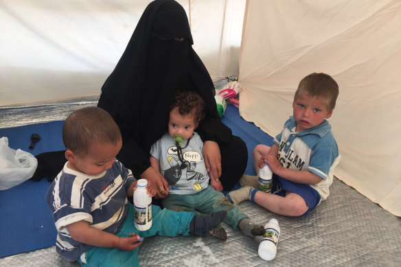 Shayma Assaad and her three sons in her tent at the al-Hawl camp.