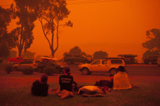 Locals watch the skies after the worst of the fires in Mallacoota on New Year's Eve.