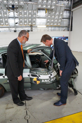 NSW Centre for Road Safety executive director Bernard Carlon and ANCAP chief executive James Goodwin point out the lack of safety features in older cars. Damage to the older vehicle was described as structurally catastrophic.