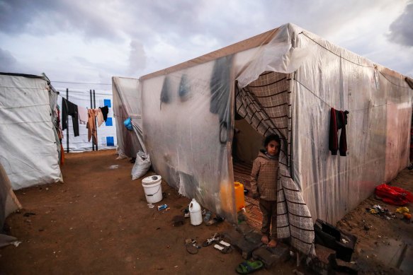 A young displaced Palestinian in a camp in Rafah, Gaza Strip, on Tuesday.  The Palestinian toll since October 7 now exceeds 25,000 dead and 62,000 injured, according to the territory’s Health Ministry. 