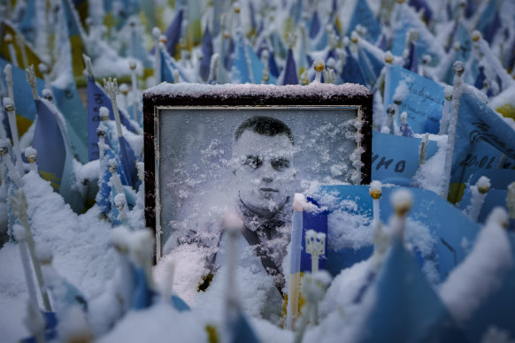 Snow covers the photograph of a fallen Ukrainian serviceman at a memorial in downtown Kyiv, Ukraine.