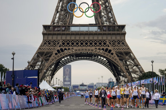 Fans cheer as athletes line up to start the men’s 20km race walk at the 2024 Summer Olympics.
