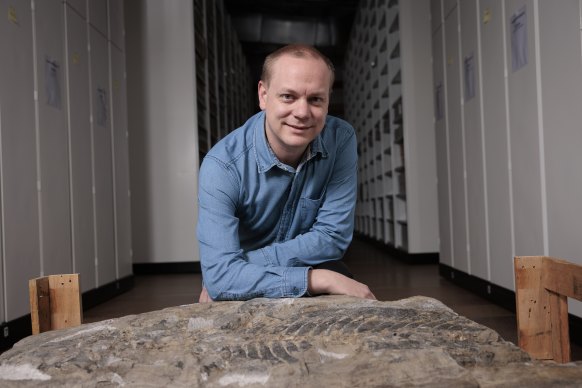 Paleontologist Lachlan Hart with the fossil he and other researchers have now formally described and named.