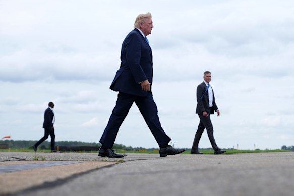 Trump walks to board Air Force One in New Jersey to fly back to Washington. 