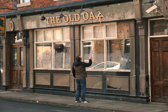 T.J. tries to fix the sign on his pub. It’s not exactly a subtle metaphor for the precarious nature of his fortunes but it does the job.